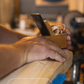 Person using a wooden plane on a piece of wood with 'Shaping the Willow' text and Trogon logo.