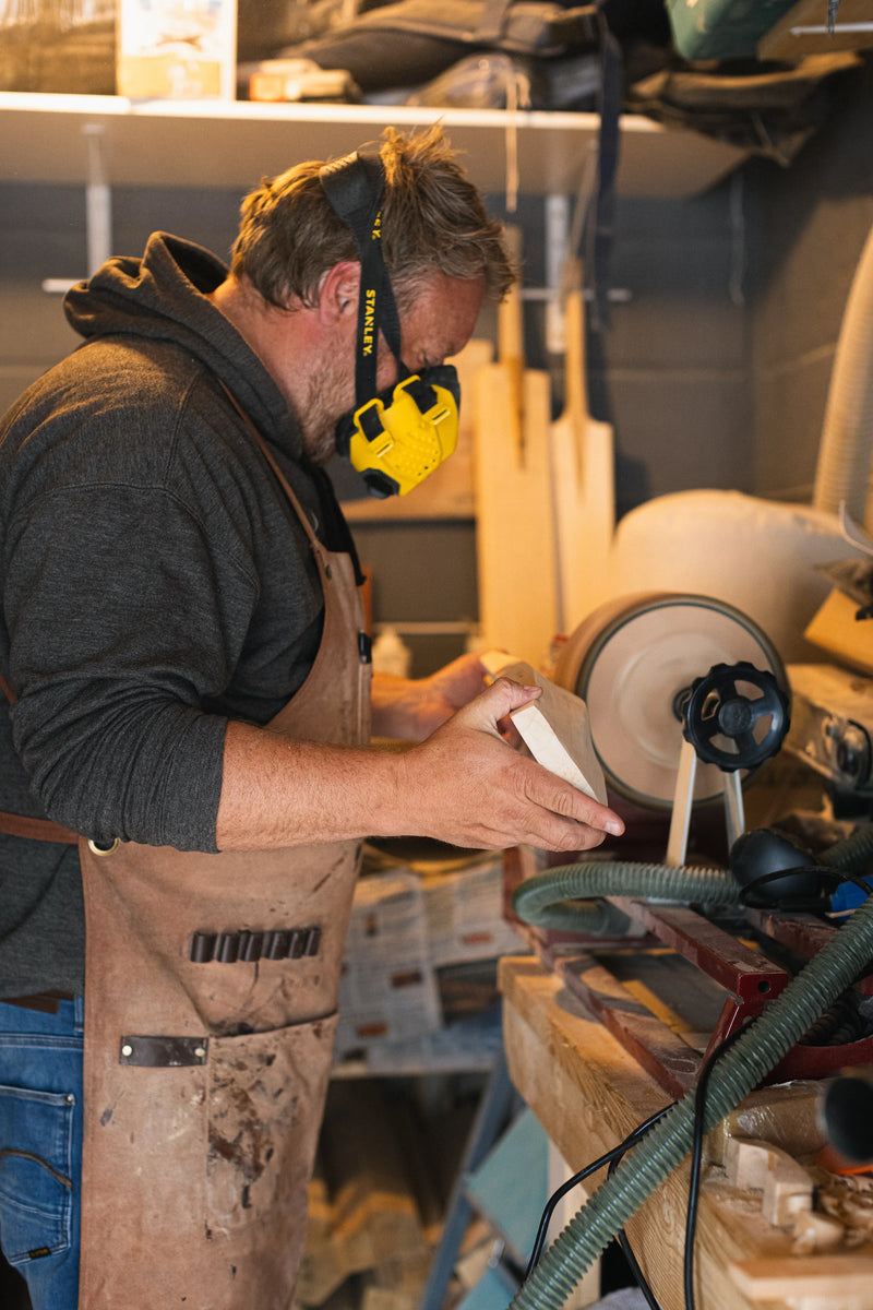 Sanding a cricket bat using a sanding drum