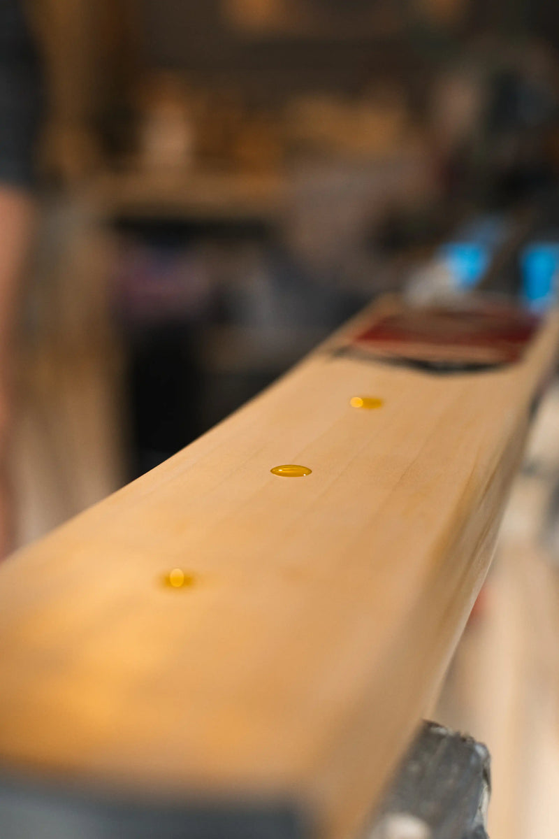 Oiling a newly created hand made cricket bat in West Sussex