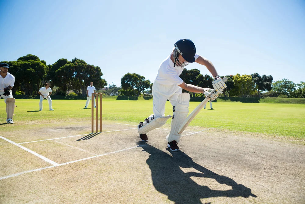 A young cricketer using a harrow cricket bat playing a perfect forward defense